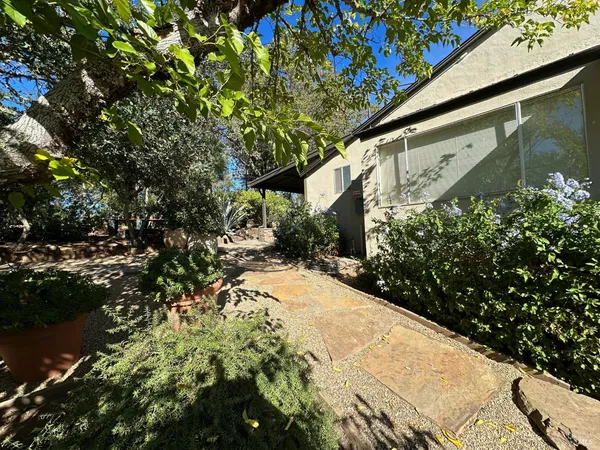 a backyard of a house with table and chairs