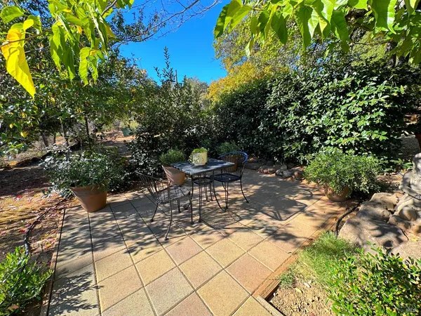a view of a chairs and table in the patio
