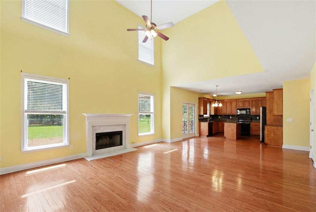 3420 Bulloch Lake Road Loganville, GA 30052 - Photo 18 of 57 a view of empty room with a fireplace and wooden floor