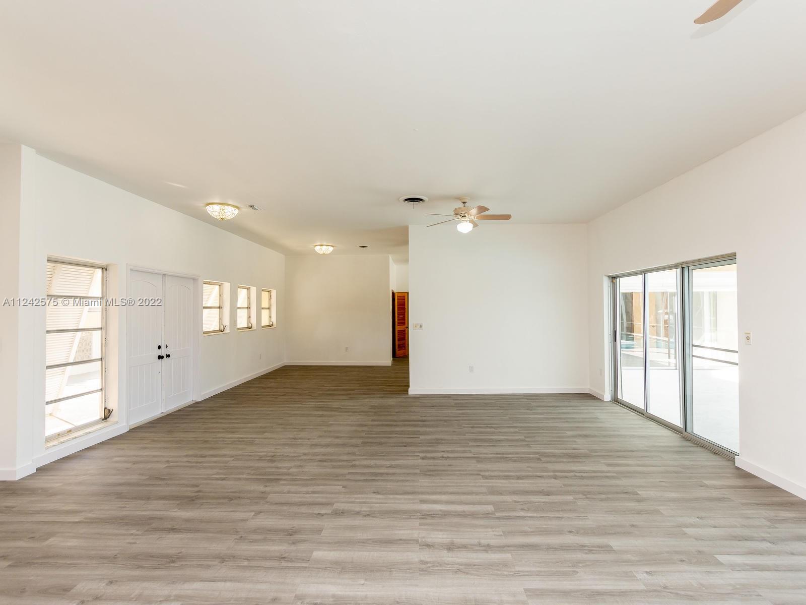 13001 Deva Street Coral Gables, FL 33156 - Photo 15 of 99 wooden floor in an empty room with a window