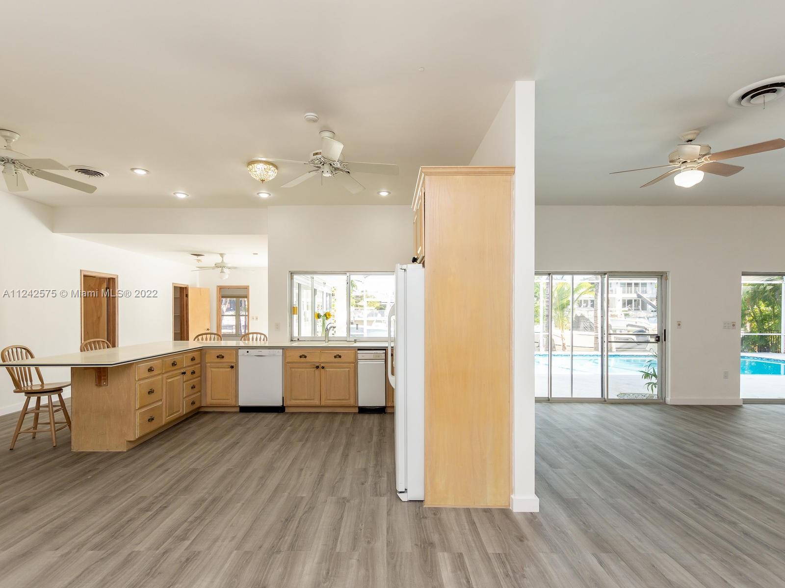 13001 Deva Street Coral Gables, FL 33156 - Photo 20 of 99 a large kitchen with lot of counter space and wooden floor