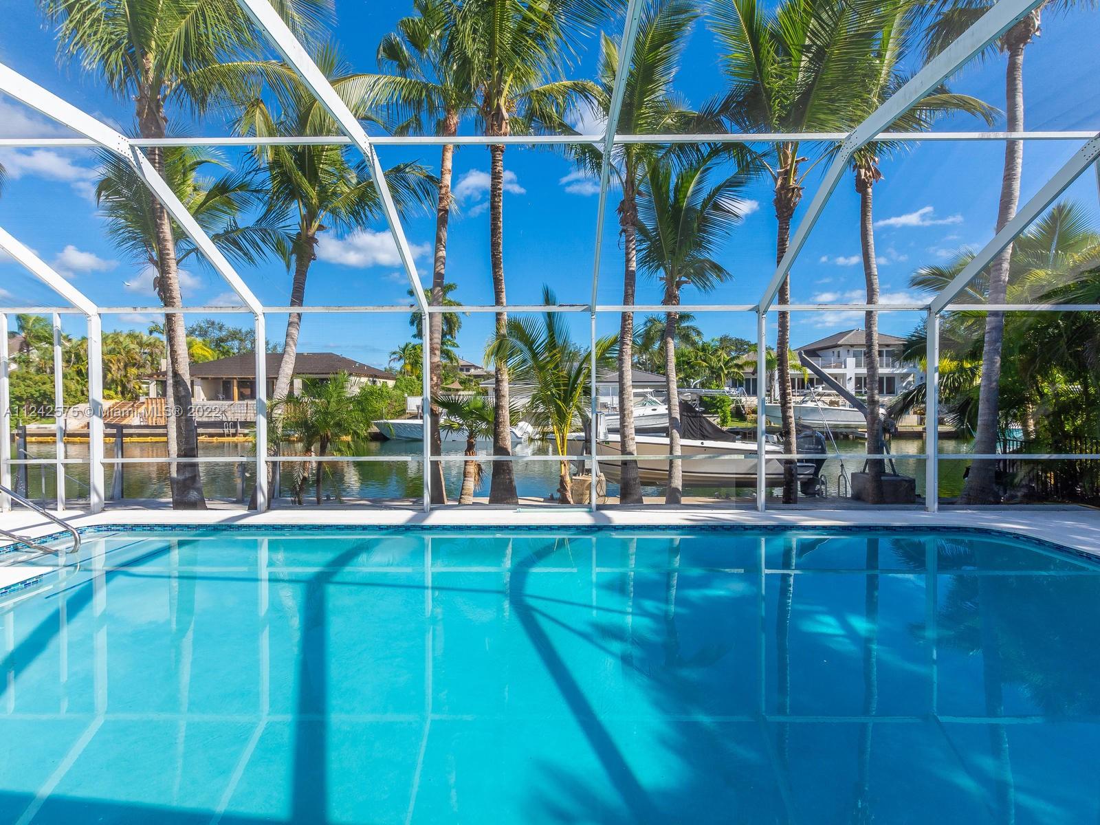 13001 Deva Street Coral Gables, FL 33156 - Photo 3 of 99 a view of a swimming pool with a yard
