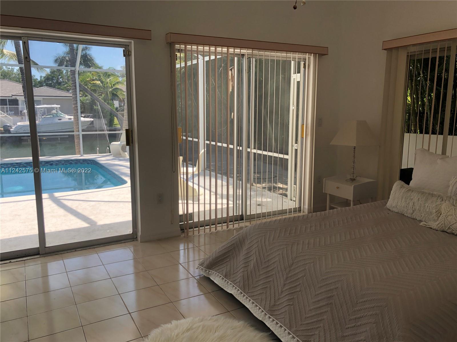 13001 Deva Street Coral Gables, FL 33156 - Photo 38 of 99 a bedroom with a bed and a large window