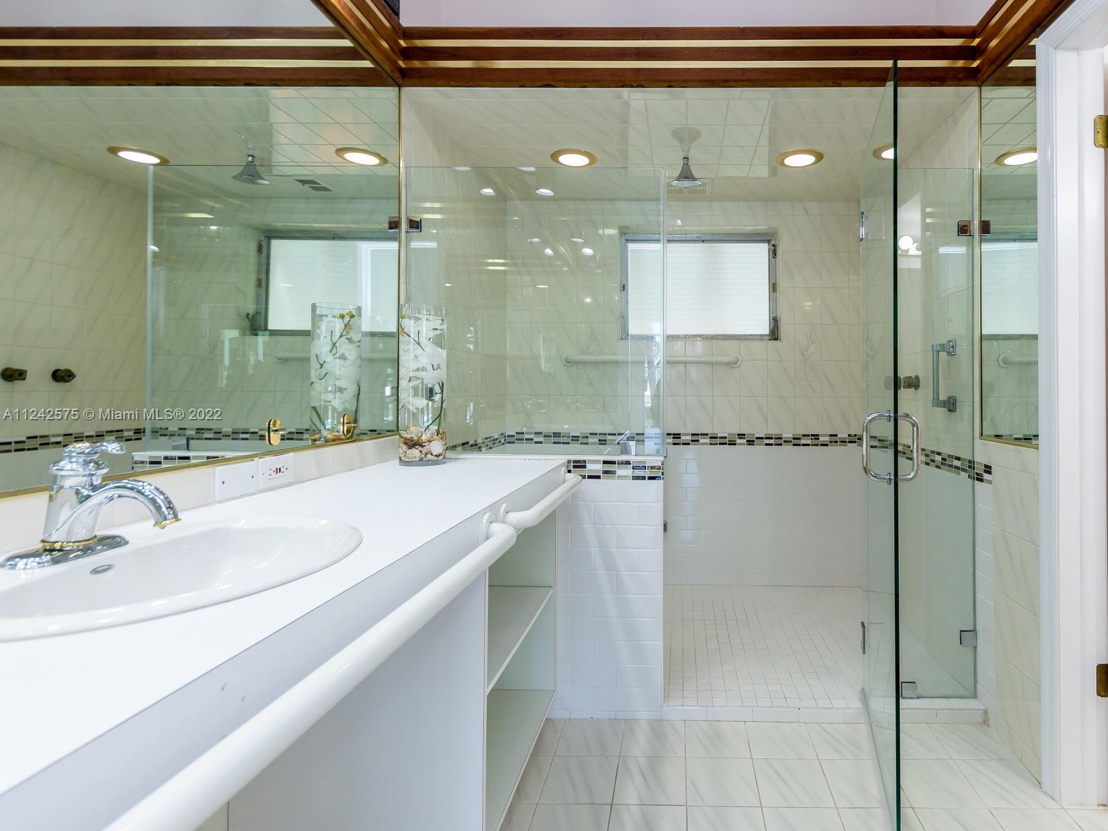 13001 Deva Street Coral Gables, FL 33156 - Photo 45 of 99 a bathroom with a sink and a mirror
