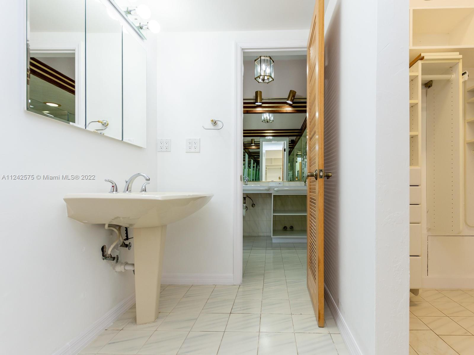 13001 Deva Street Coral Gables, FL 33156 - Photo 47 of 99 a bathroom with a sink and mirror