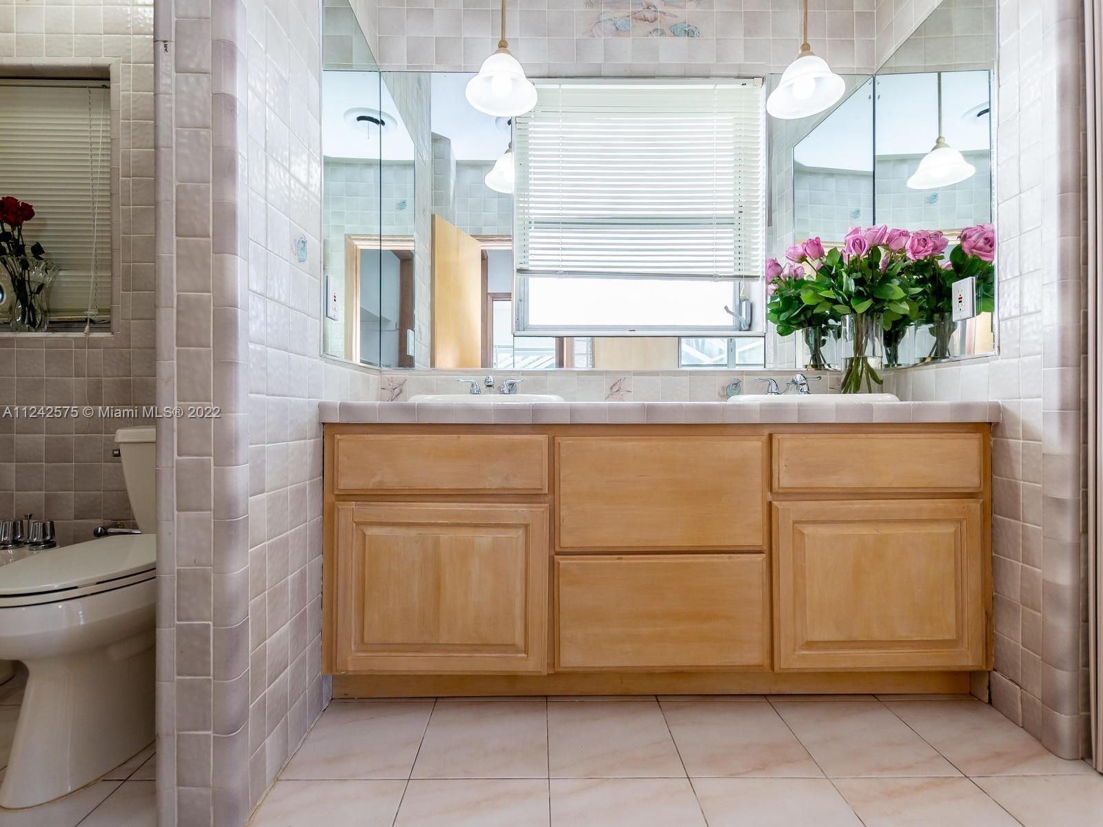 13001 Deva Street Coral Gables, FL 33156 - Photo 53 of 99 a bathroom with a sink and mirror