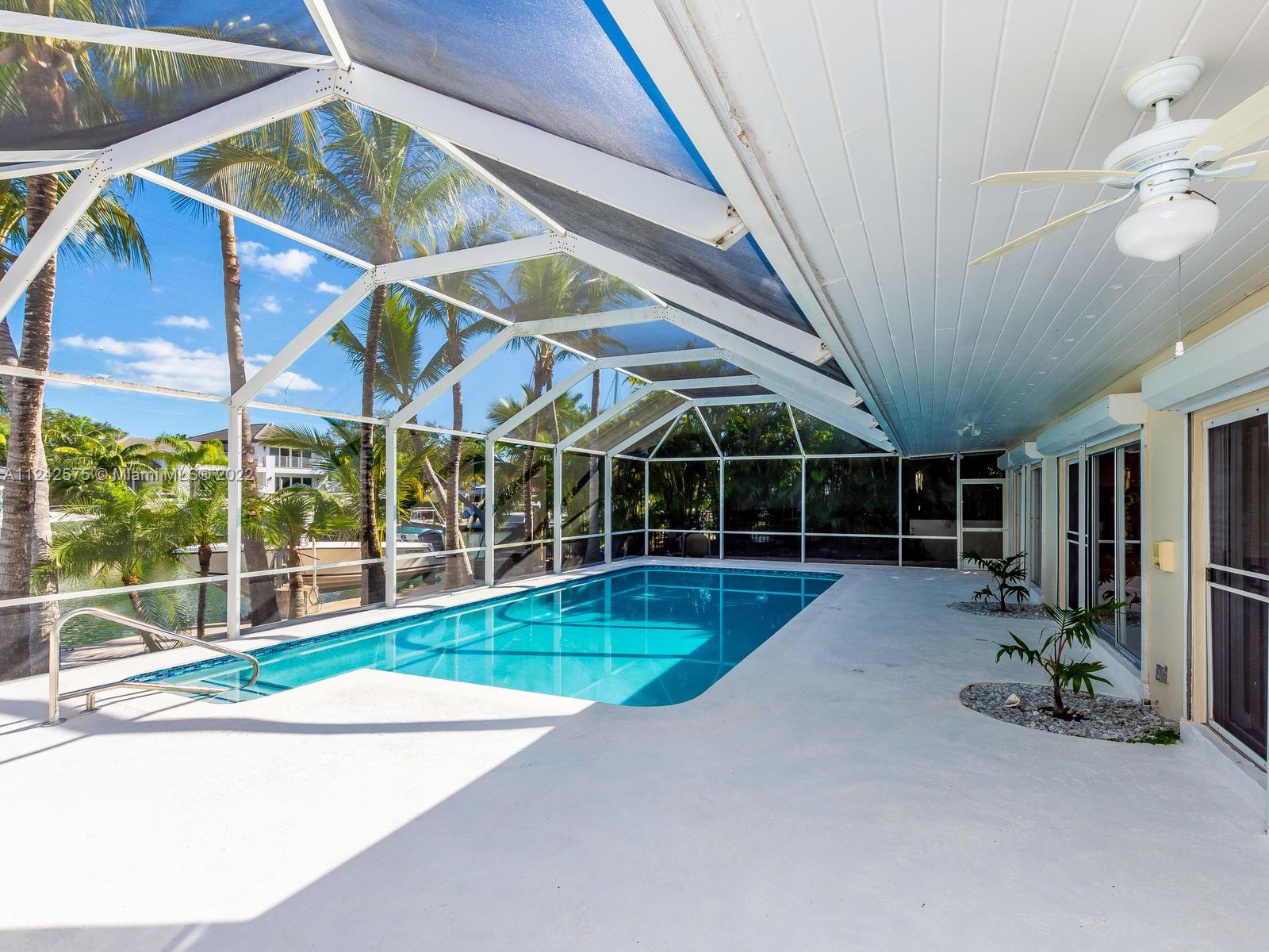 13001 Deva Street Coral Gables, FL 33156 - Photo 67 of 99 a view of a backyard with porch area of the table and chairs