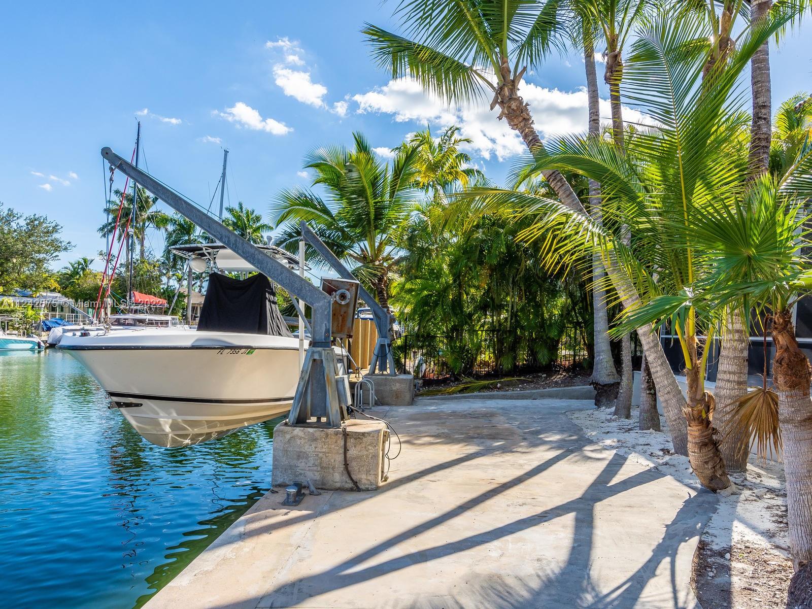 13001 Deva Street Coral Gables, FL 33156 - Photo 84 of 99 a view of a swimming pool with a patio and a yard