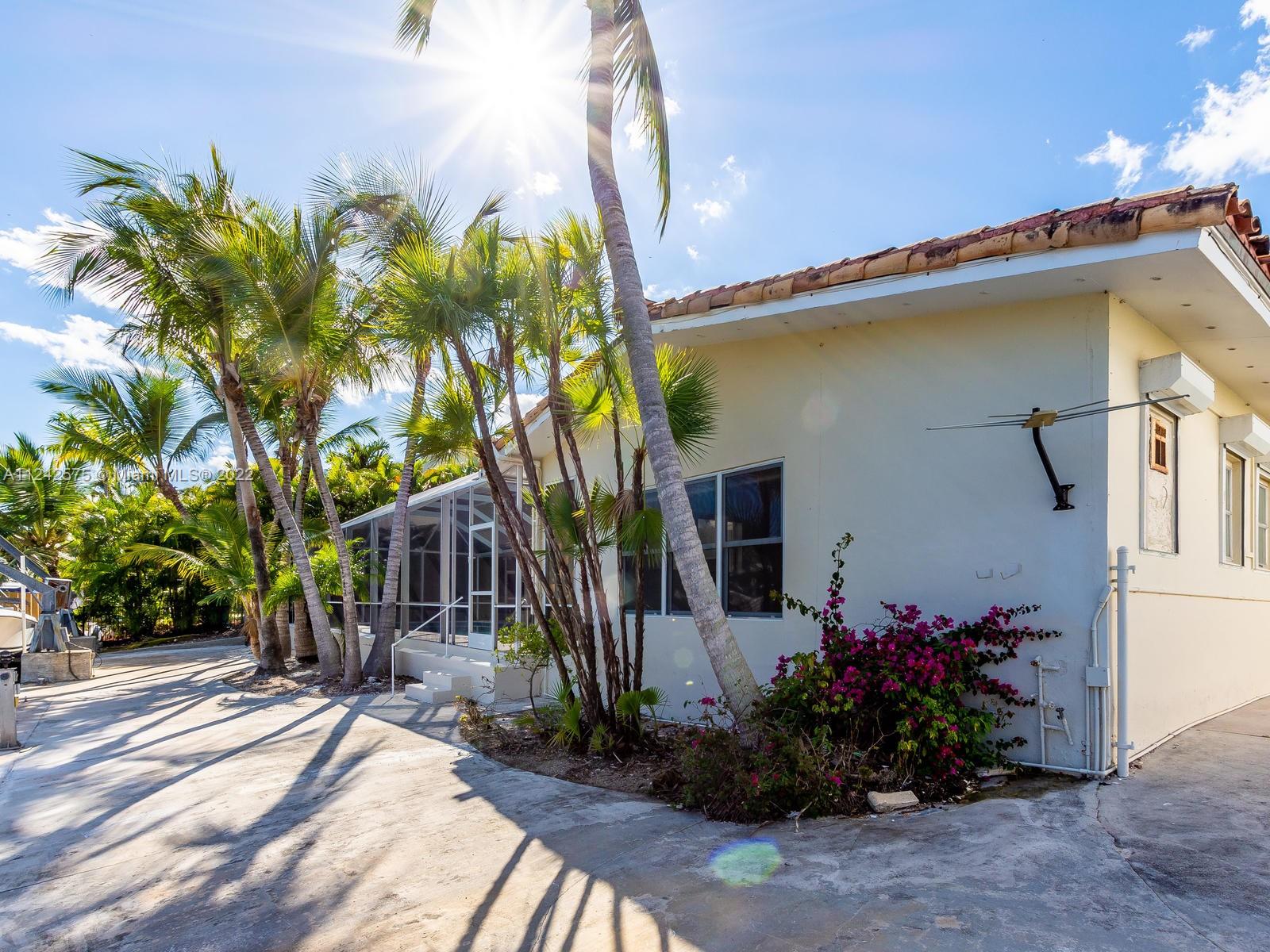 13001 Deva Street Coral Gables, FL 33156 - Photo 86 of 99 a front view of a house with a yard