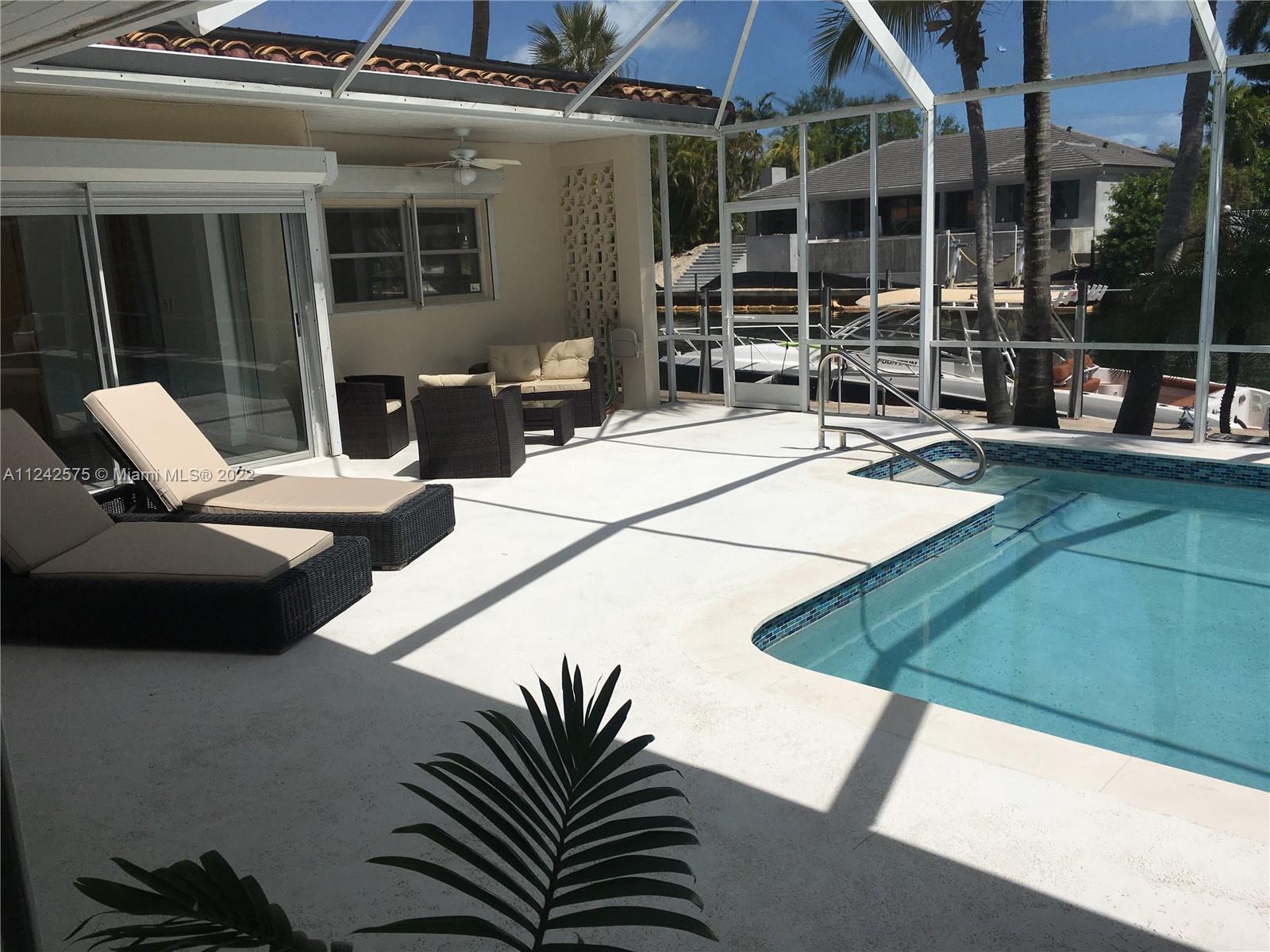 13001 Deva Street Coral Gables, FL 33156 - Photo 88 of 99 a view of a patio with table and chairs with wooden floor and fence