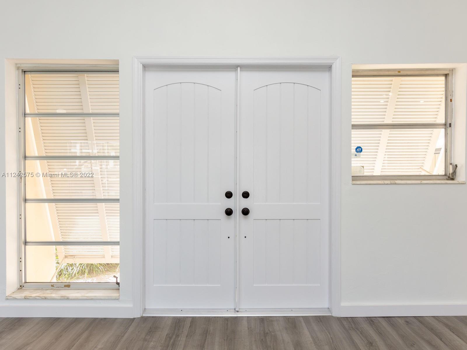 13001 Deva Street Coral Gables, FL 33156 - Photo 10 of 99 a view of an empty room with wooden floor and cabinet