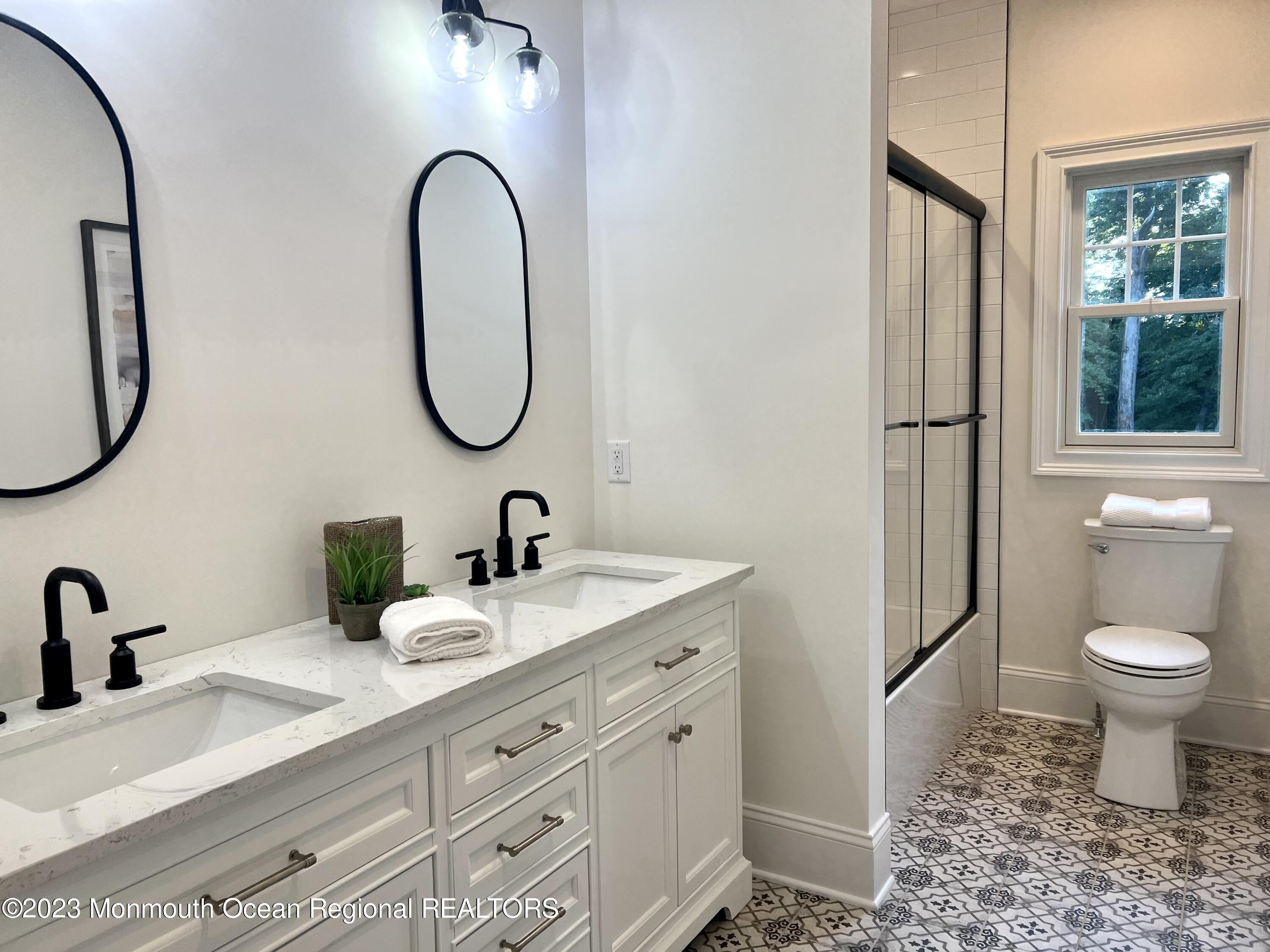 4 Southall Lane Red Bank, NJ 07701 - Photo 25 of 41 a bathroom with a toilet sink and mirror