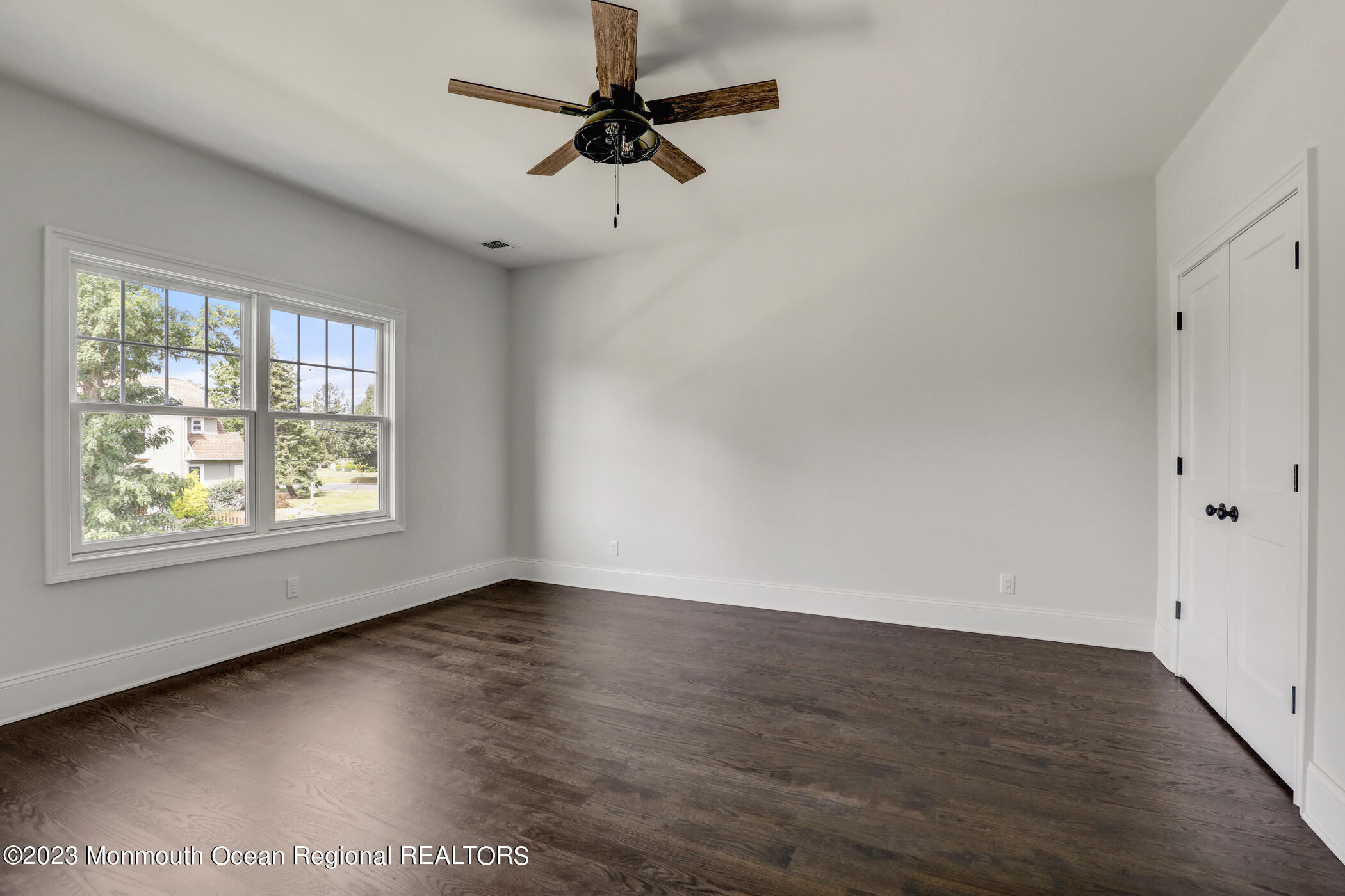 4 Southall Lane Red Bank, NJ 07701 - Photo 26 of 41 an empty room with wooden floor fan and windows