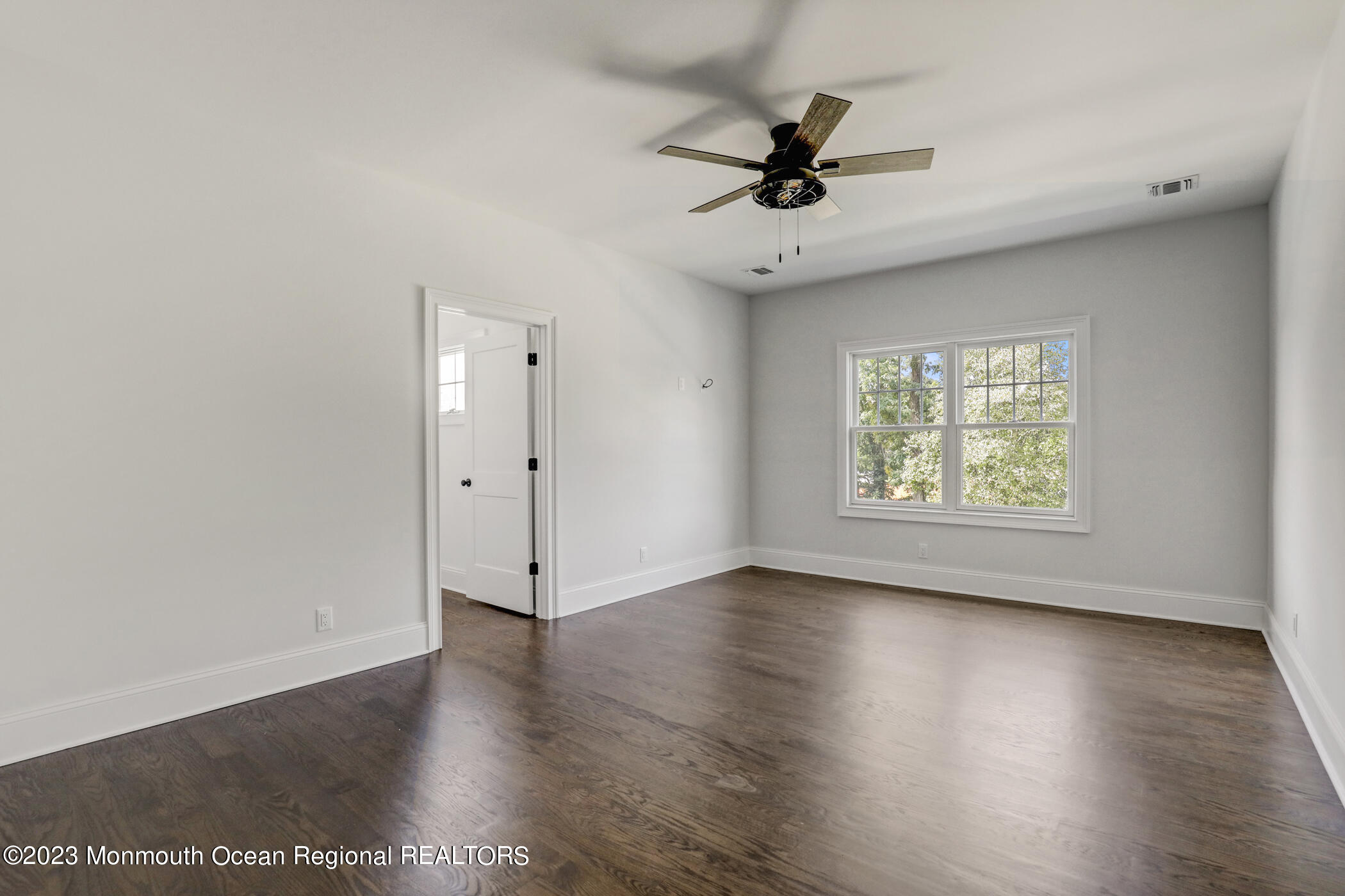 4 Southall Lane Red Bank, NJ 07701 - Photo 27 of 41 an empty room with wooden floor chandelier fan and windows