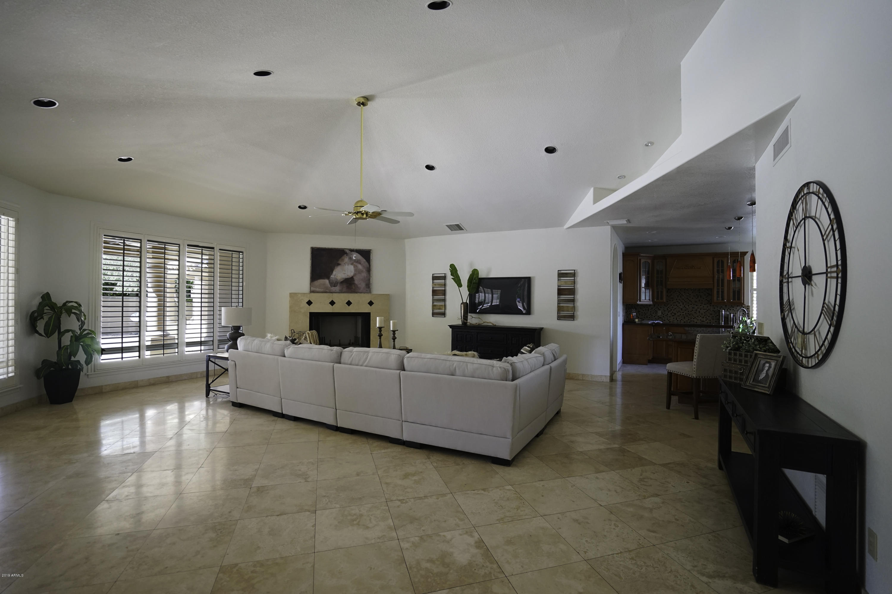 1225 East Warner Road, Unit 6 Tempe, AZ 85284 - Photo 15 of 86 a living room with furniture a fireplace and gym equipment
