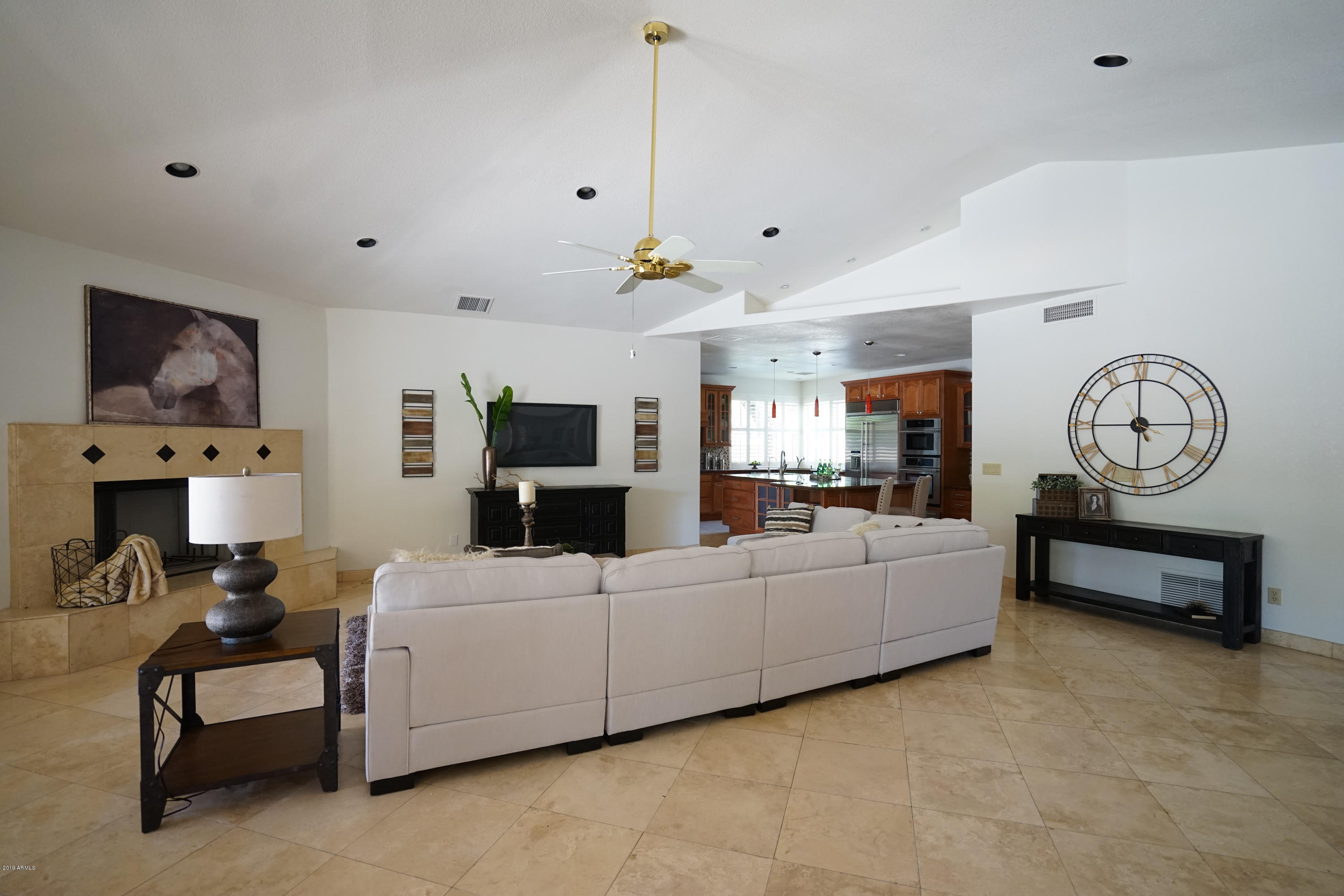 1225 East Warner Road, Unit 6 Tempe, AZ 85284 - Photo 16 of 86 a living room with furniture a clock and a flat screen tv