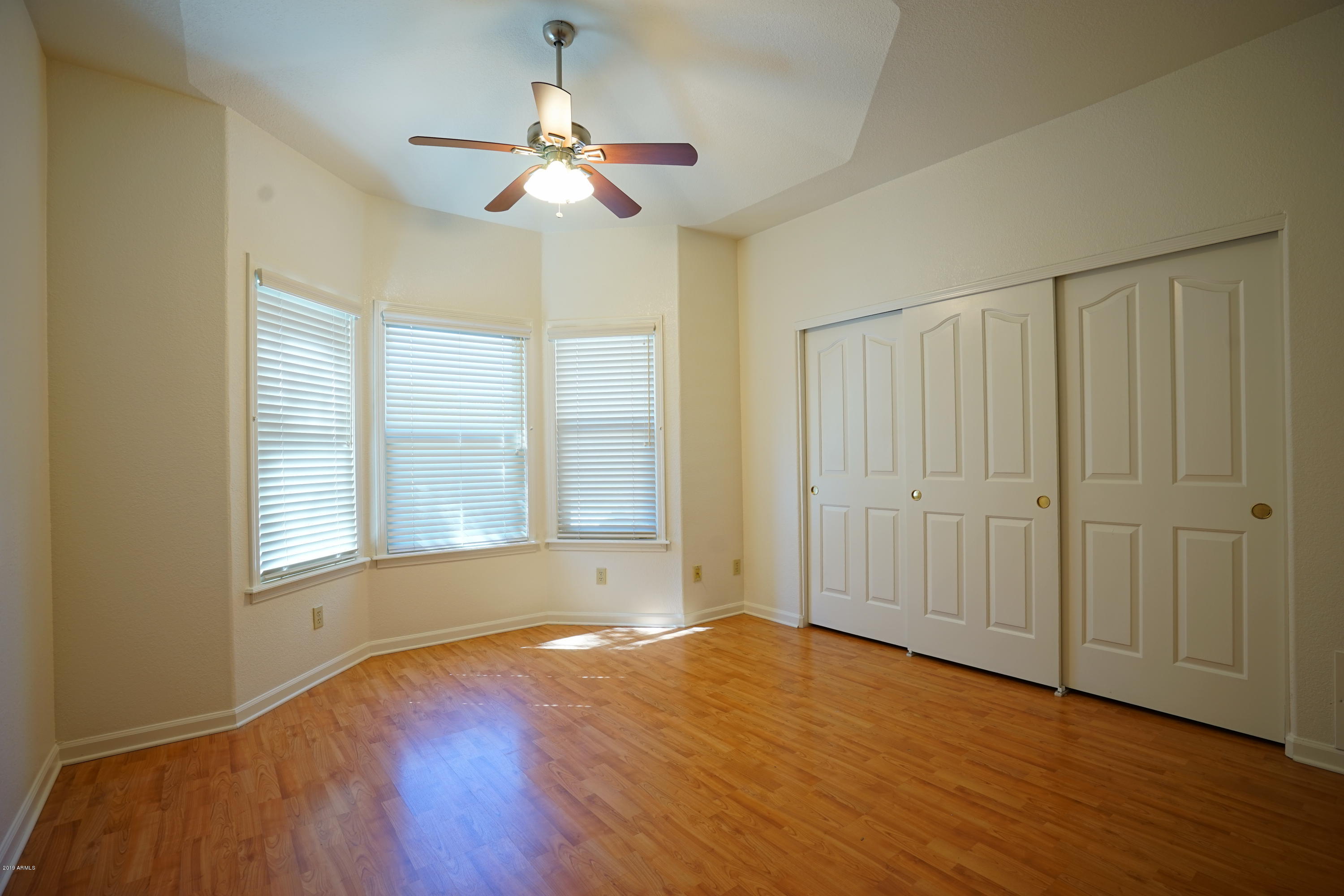 1225 East Warner Road, Unit 6 Tempe, AZ 85284 - Photo 41 of 86 a view of an empty room with wooden floor and a window