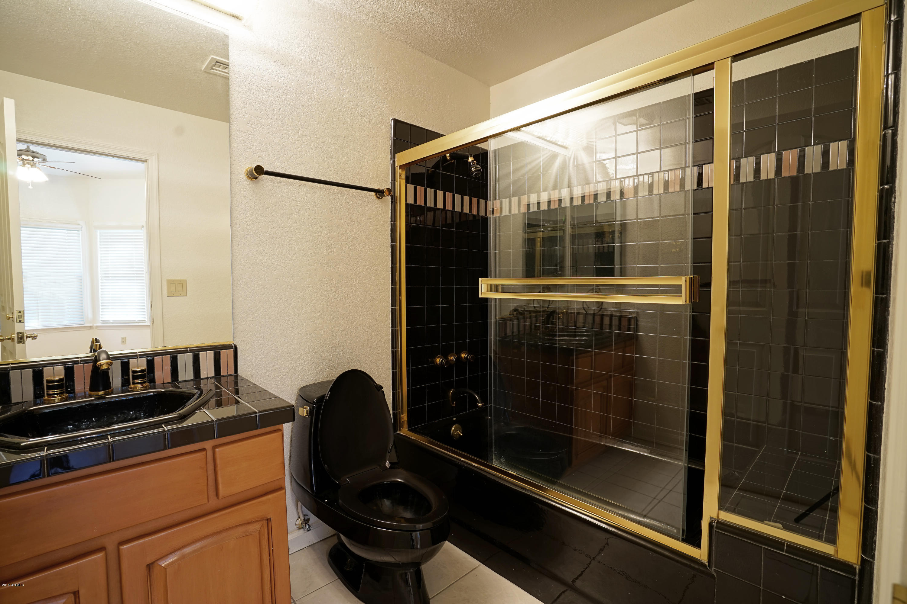 1225 East Warner Road, Unit 6 Tempe, AZ 85284 - Photo 42 of 86 a bathroom with a glass door shower and mirror