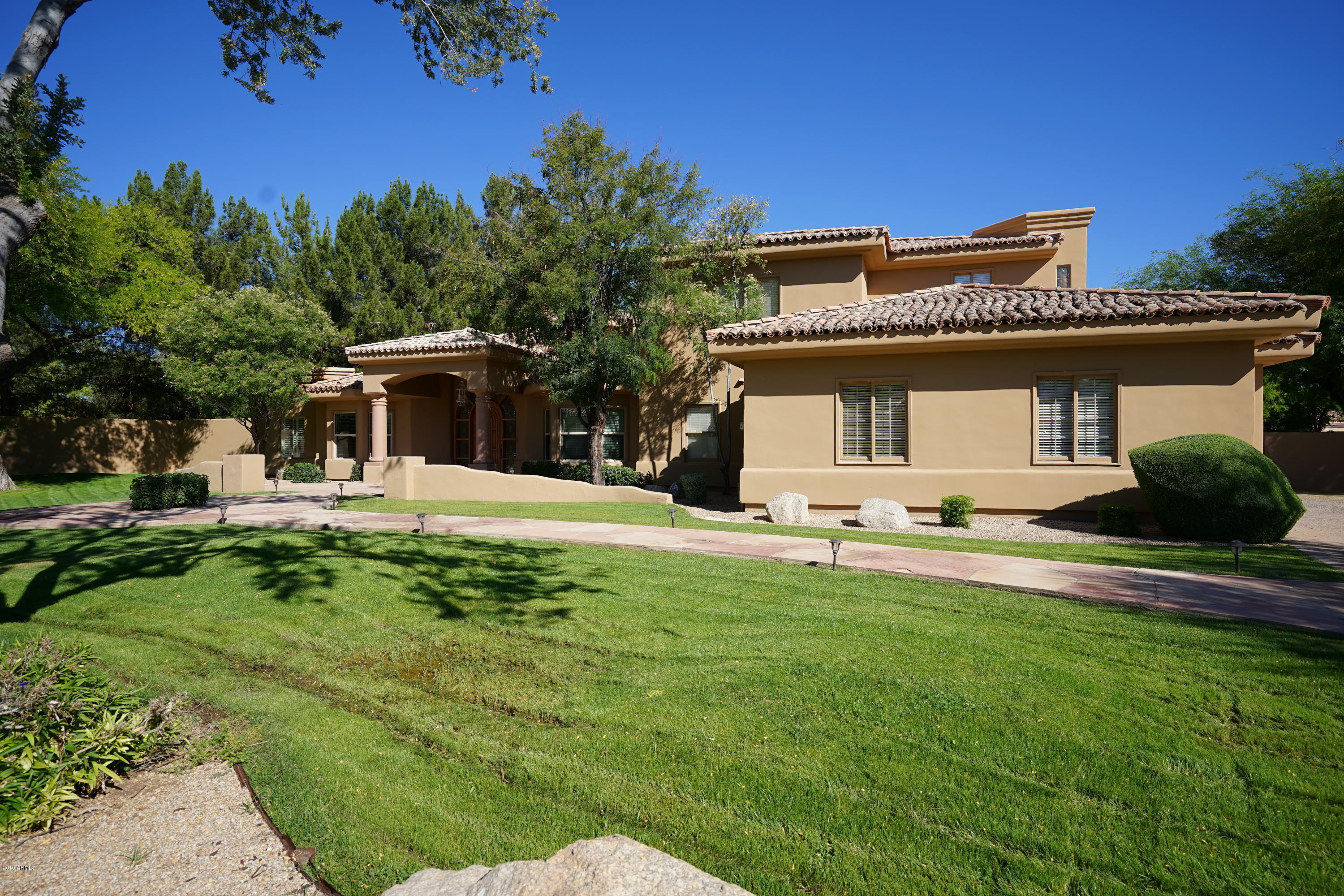1225 East Warner Road, Unit 6 Tempe, AZ 85284 - Photo 74 of 86 a front view of a house with a yard