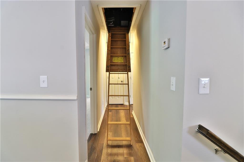 353 Fall View Court Winder, GA 30680 - Photo 34 of 61 a view of a hallway with wooden floor and staircase