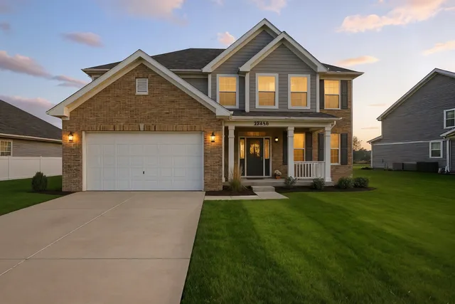 a front view of a house with a yard
