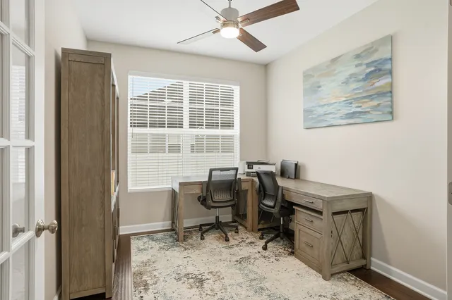 a view of a workspace with furniture and a window
