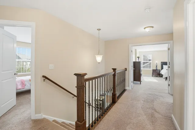 a view of a hallway with bedroom and wooden floor