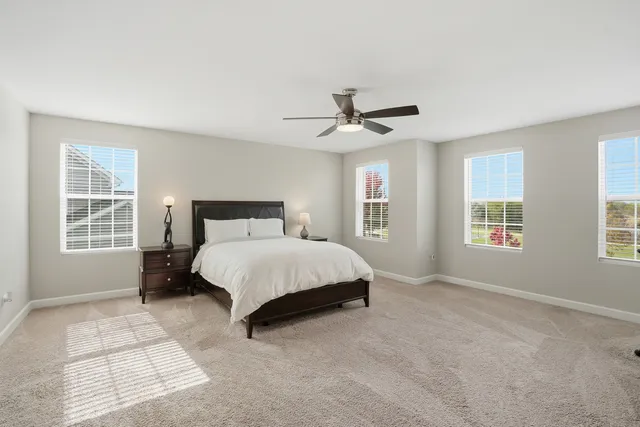 a spacious bedroom with a large bed and a window