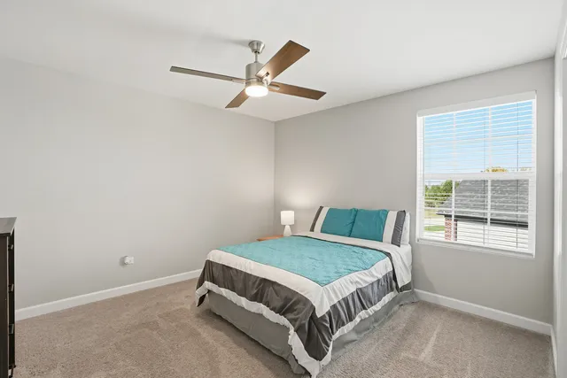 a bedroom with a bed and window