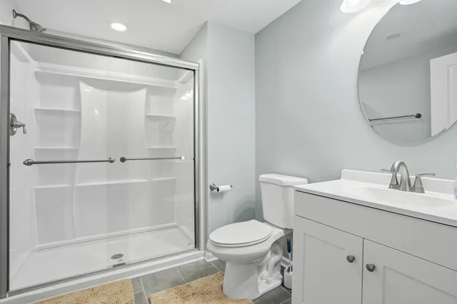 a bathroom with a toilet a sink and shower