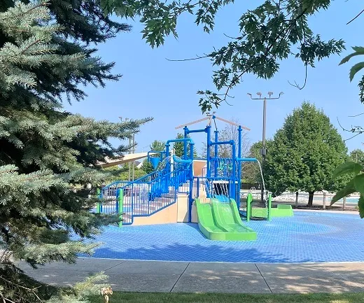 a view of outdoor space with playground and green space