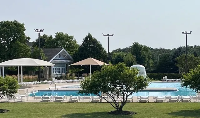 a view of a chairs and table under an umbrella in patio