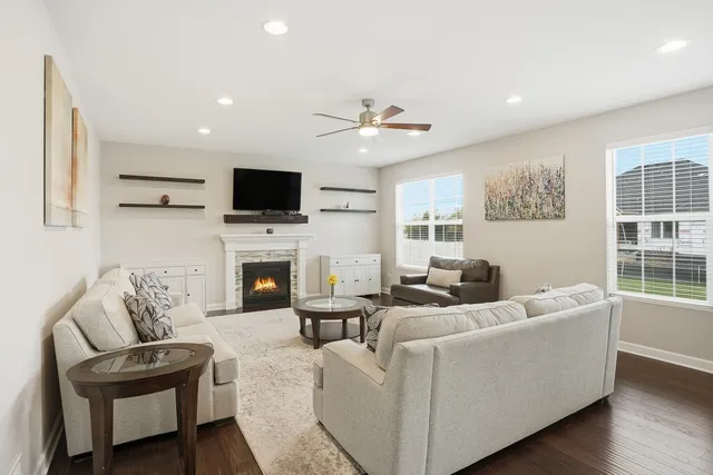 a living room with furniture a fireplace and a flat screen tv