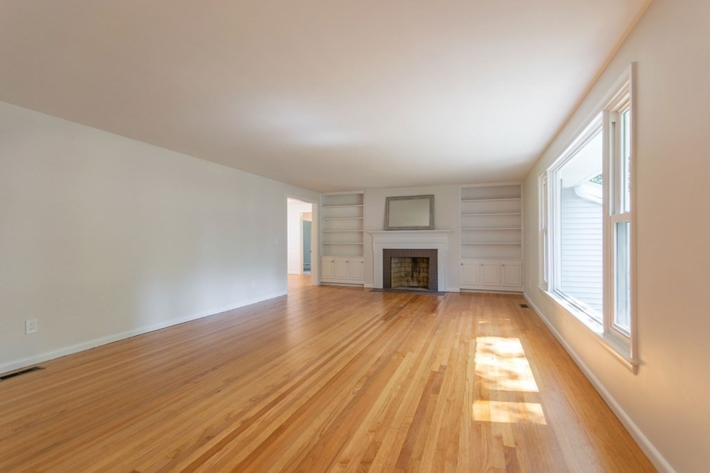 19 Robin Road Longmeadow, MA 01106 - Photo 18 of 39 an empty room with wooden floor fireplace and windows