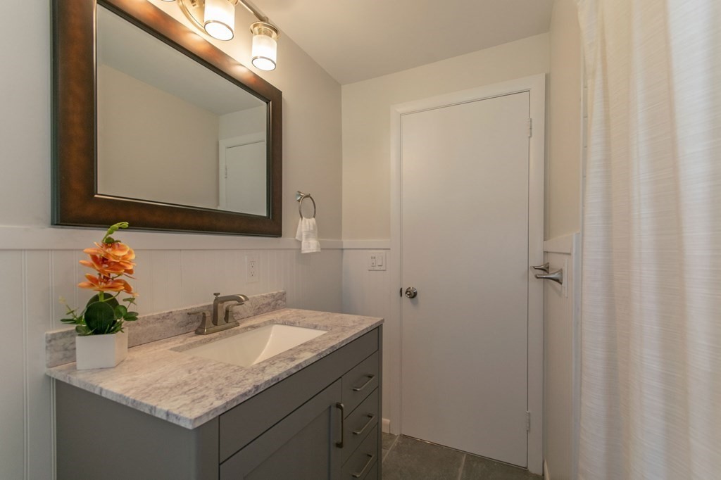 19 Robin Road Longmeadow, MA 01106 - Photo 23 of 39 a bathroom with a granite countertop sink and a mirror