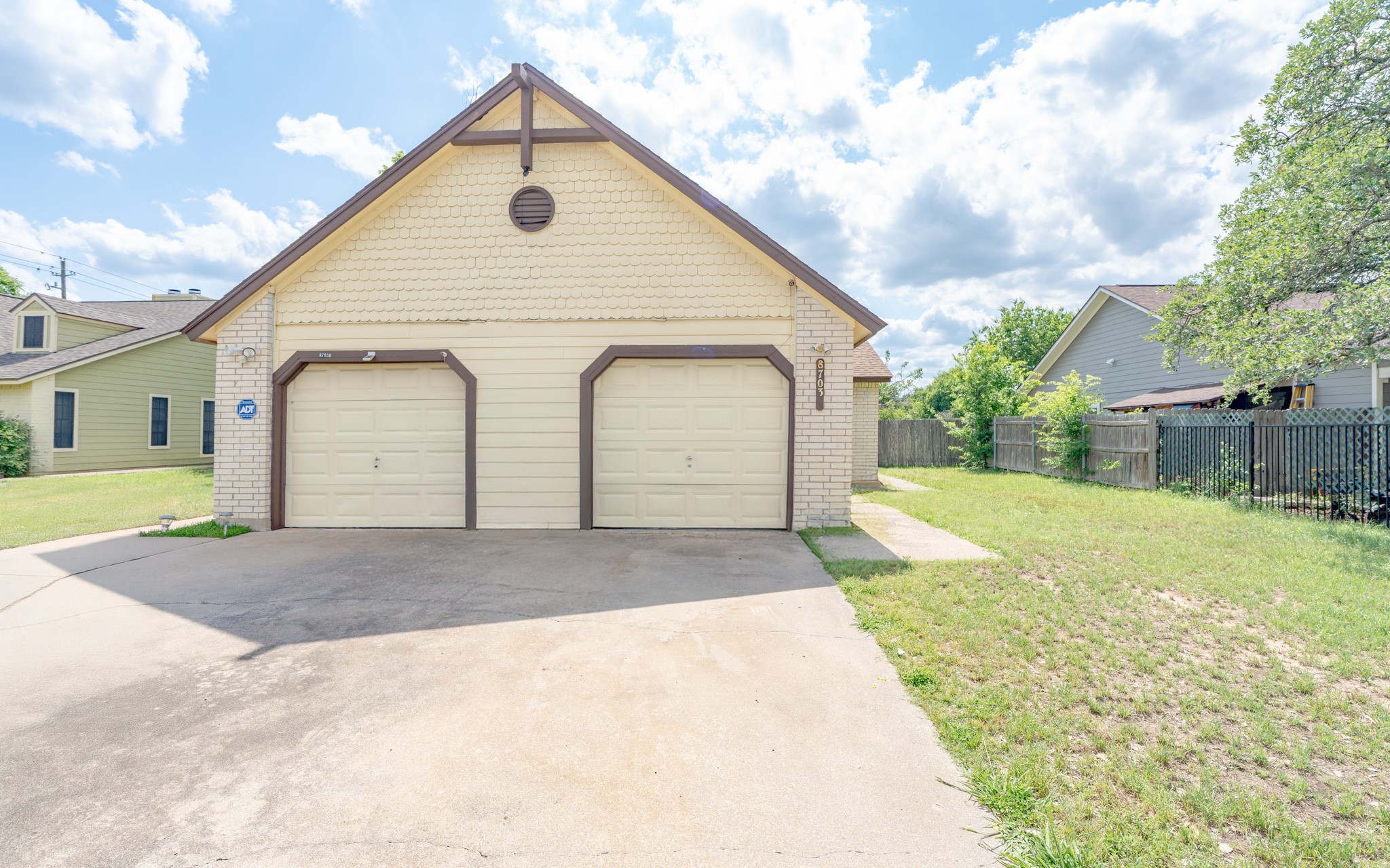 a view of backyard of house with outdoor seating and barbeque oven