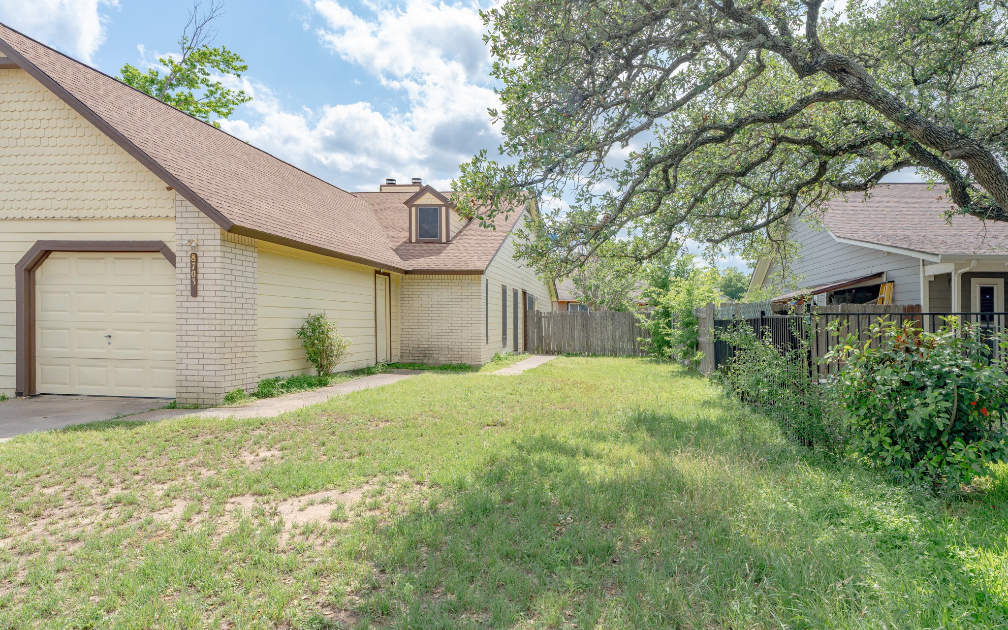 8703 Clearbrook Trail Austin, TX 78729 - Photo 2 of 9 a front view of a house with a yard and garage