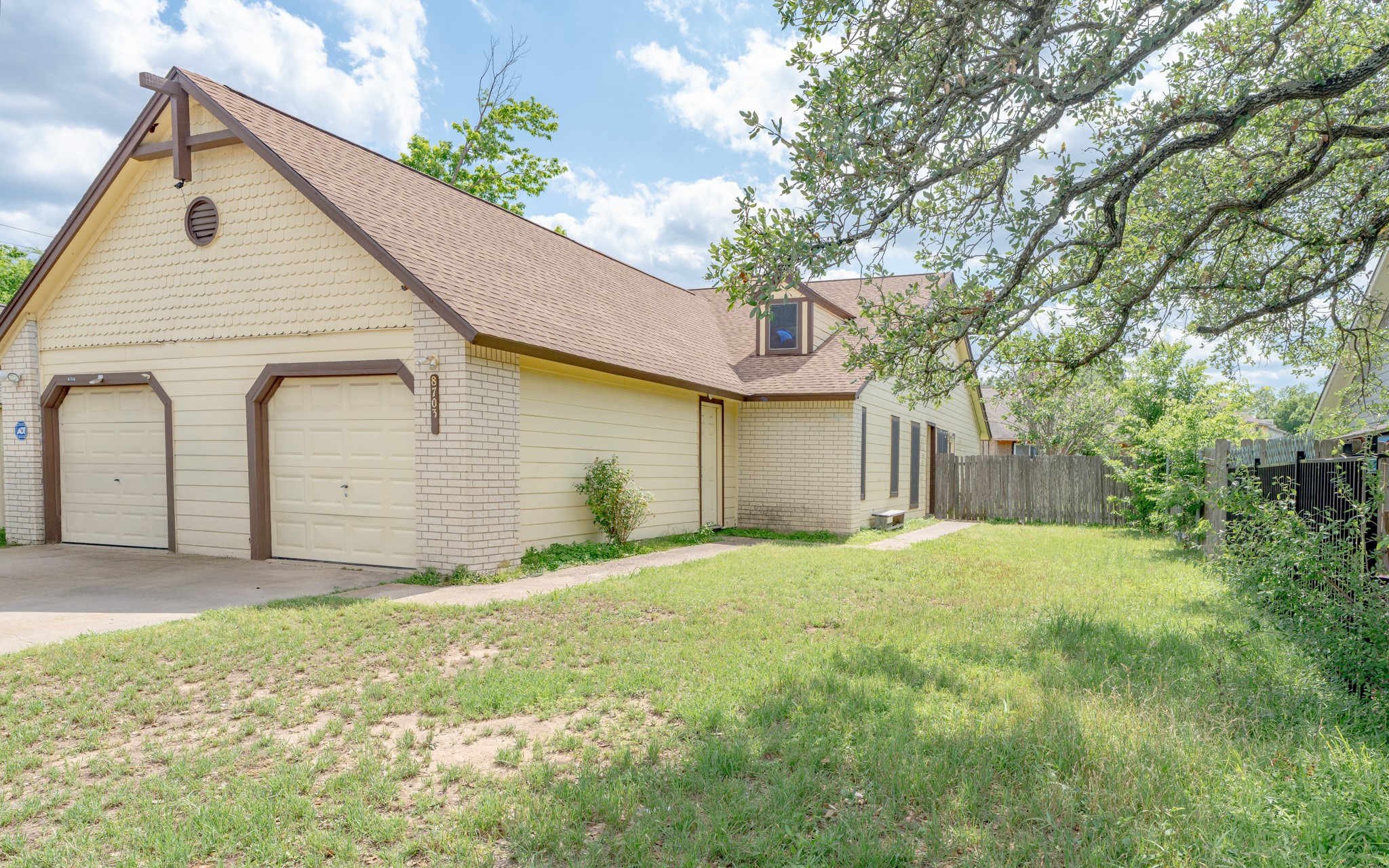 8703 Clearbrook Trail Austin, TX 78729 - Photo 3 of 9 a view of a house with a yard and garage