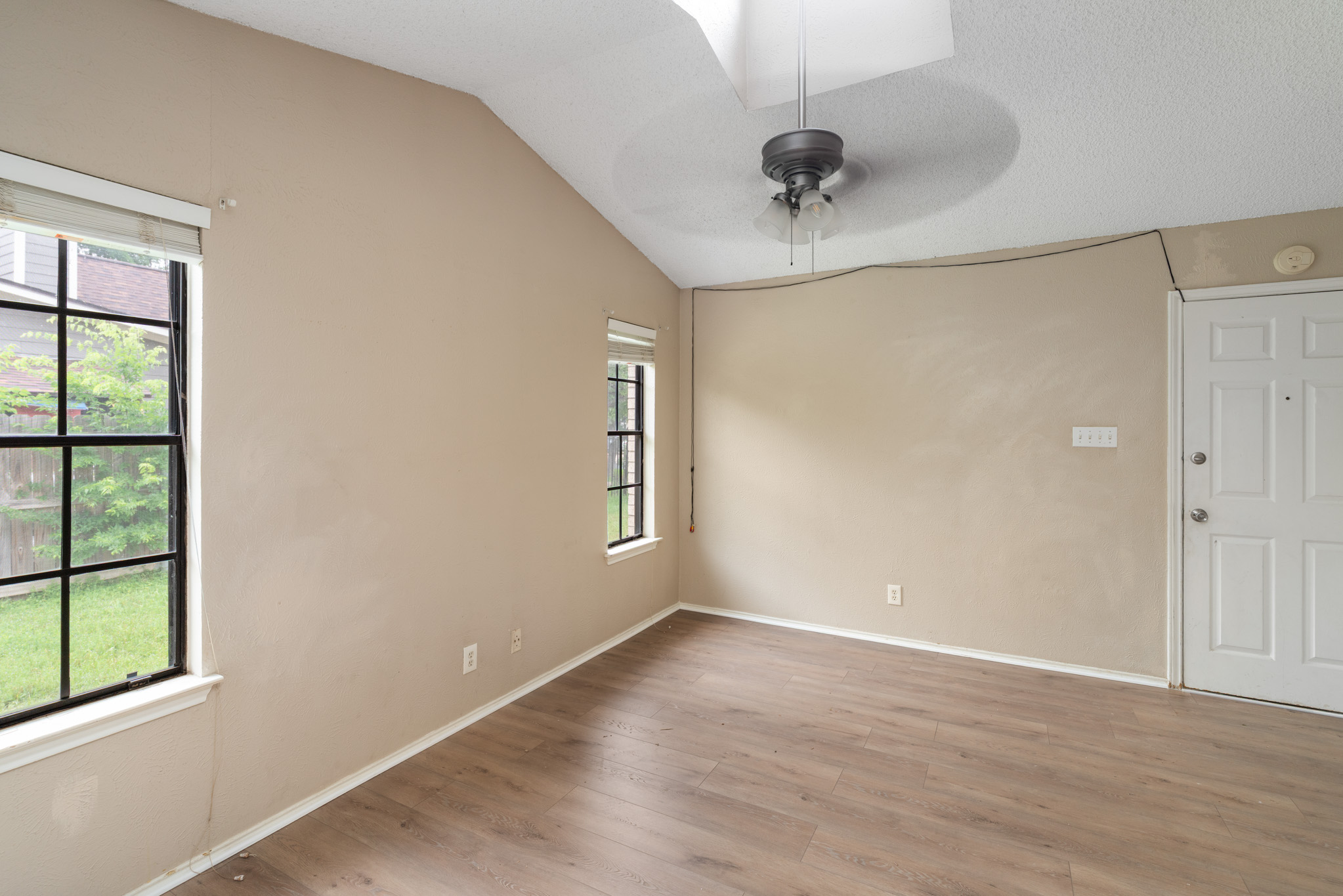 8703 Clearbrook Trail Austin, TX 78729 - Photo 6 of 9 wooden floor in an empty room with a window