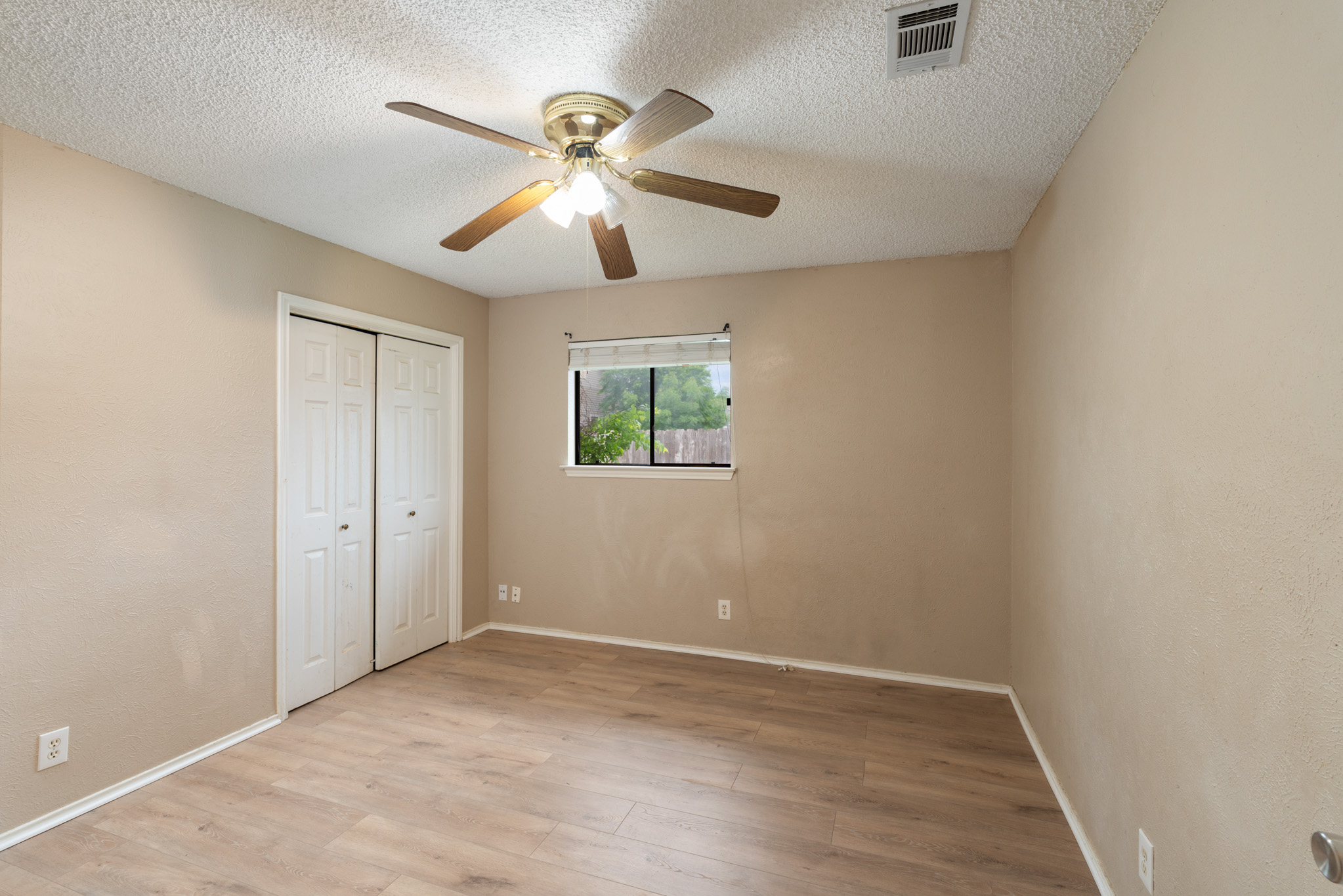 8703 Clearbrook Trail Austin, TX 78729 - Photo 7 of 9 an empty room with a window and a fan