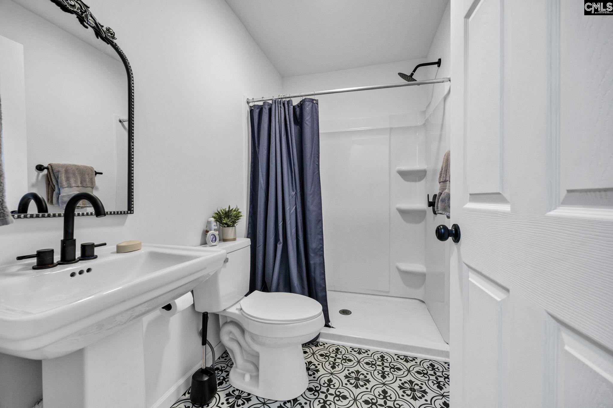 8107 Black River Road Rembert, SC 29128 - Photo 29 of 38 a bathroom with a sink toilet and shower