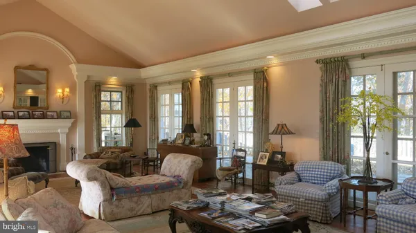 a living room with furniture fireplace and a large window