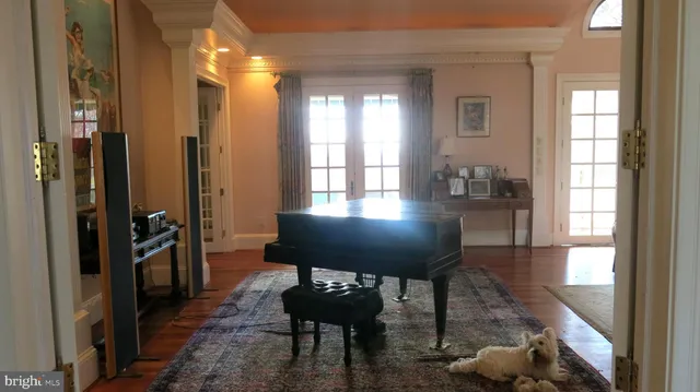 a bedroom with furniture and a large window