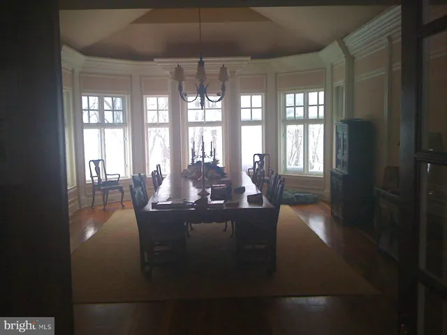 a living room with furniture a table and wooden floor