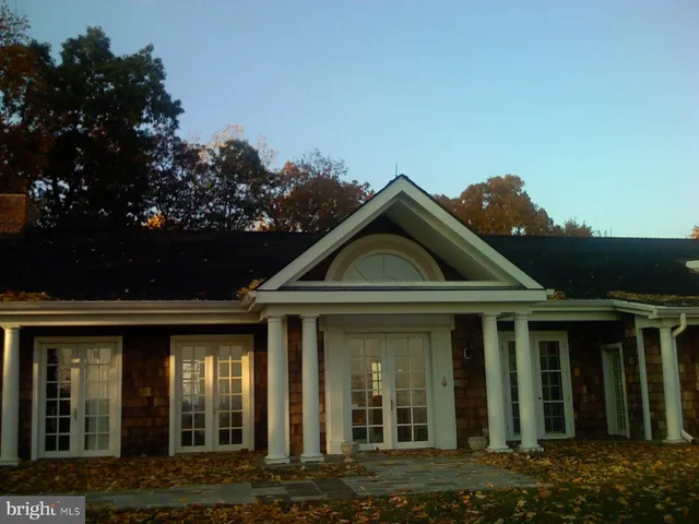 a view of a chair and table in the backyard