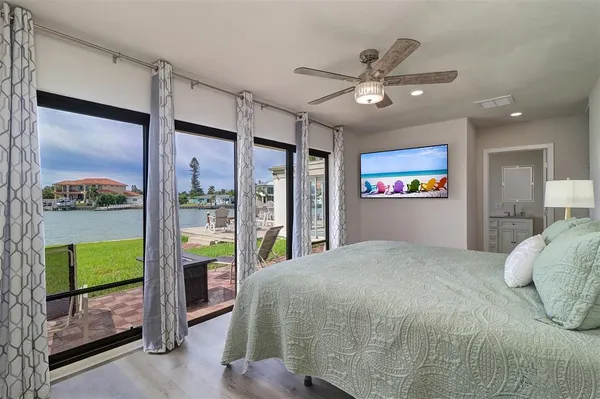 a bedroom with a large bed and a chandelier