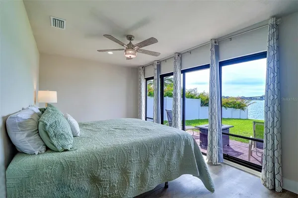 a bedroom with a large bed and a large window