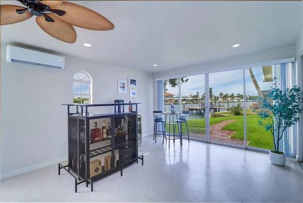 a living room with furniture and a floor to ceiling window
