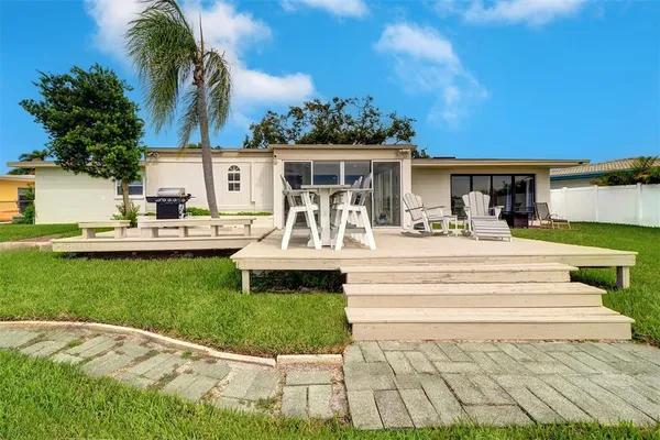 a view of a house with a backyard porch and sitting area