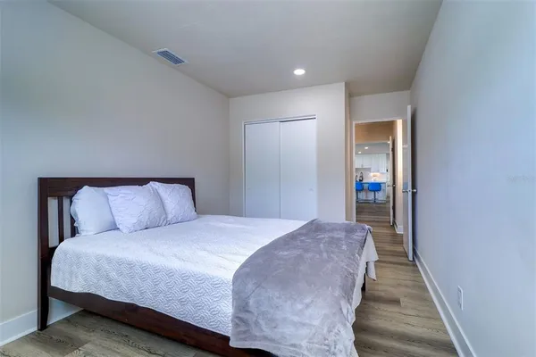 a bed room with a bed and a mirror